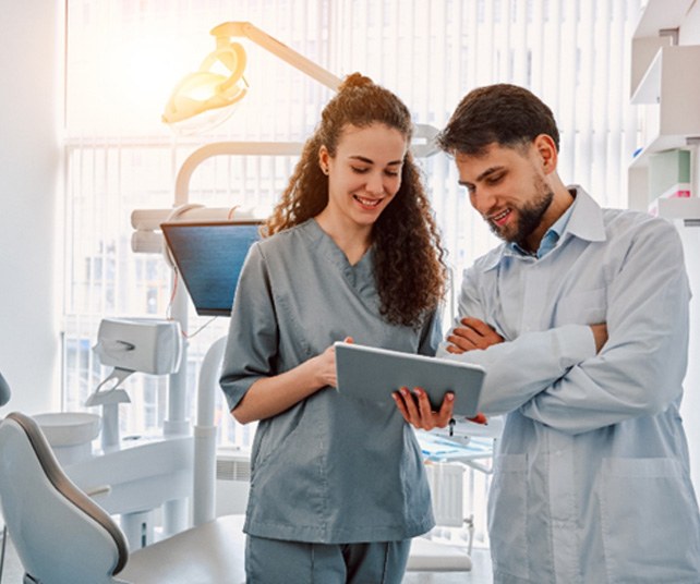 Dental assistant talking to patient 