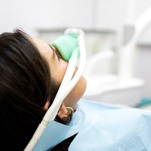 Patient with nasal mask sitting in treatment chair