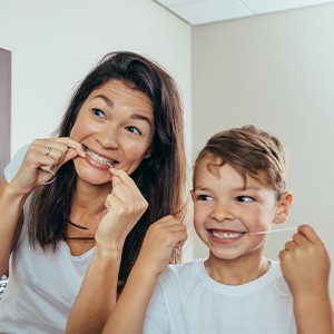 Patient in Little Ferry flossing to avoid a dental emergency